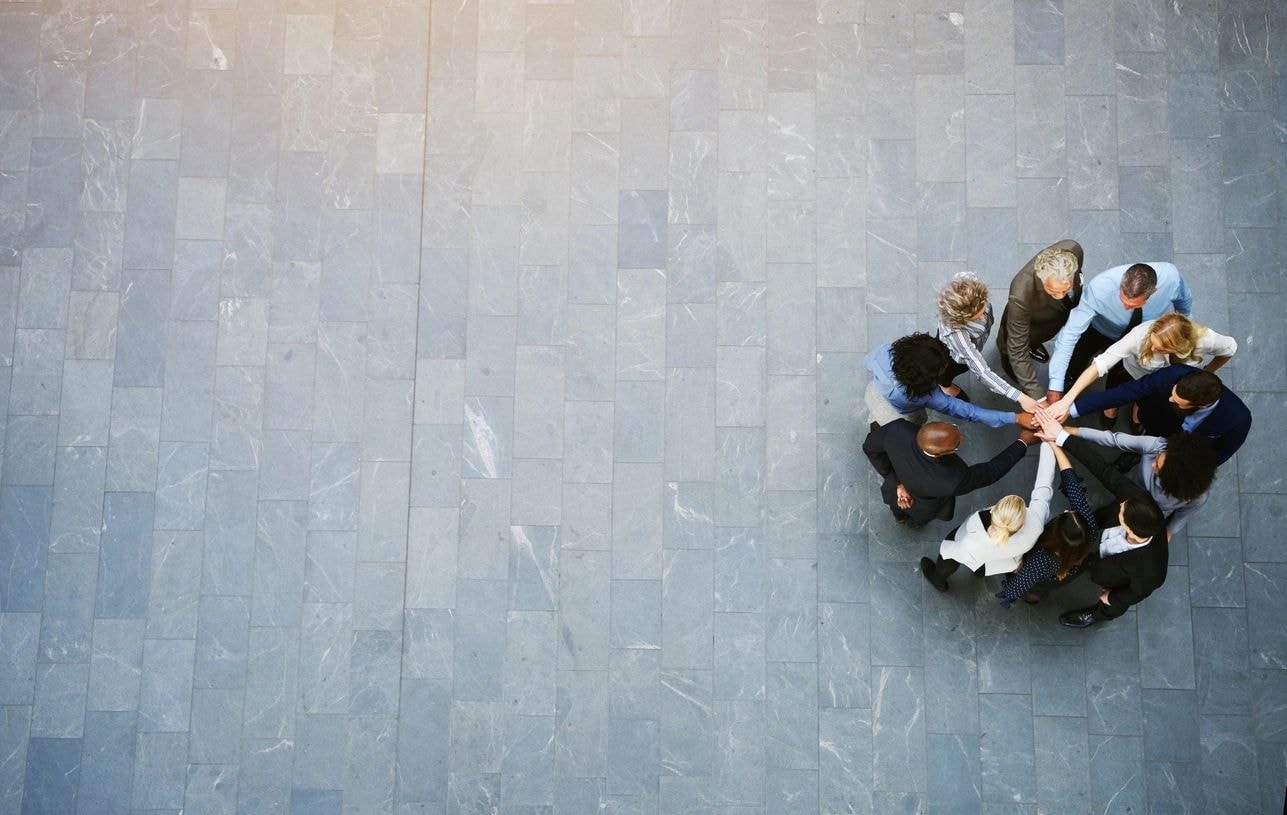 Business professionals in a circle symbolizing teamwork and collaboration